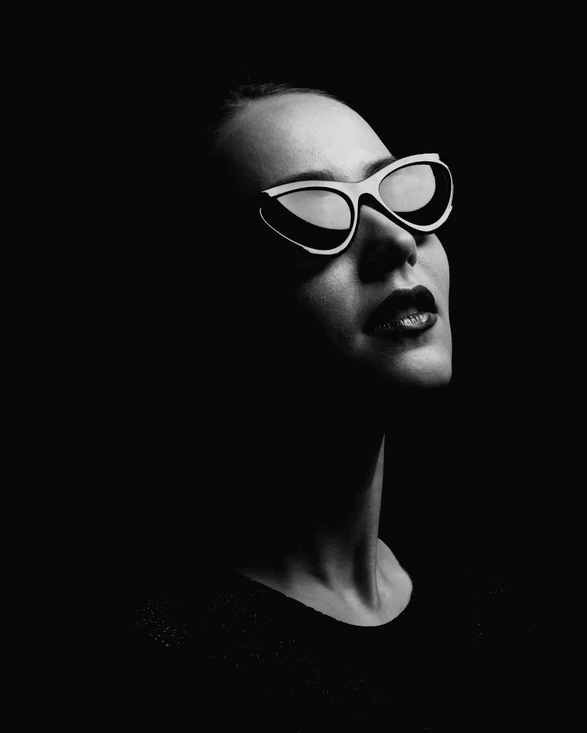 A close portrait, jewellery catching light.